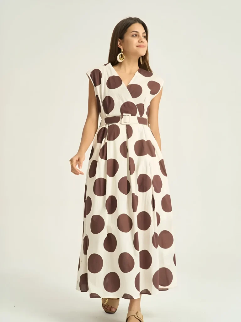 Cream polka dot midi dress worn with tan sandals, full length front view
