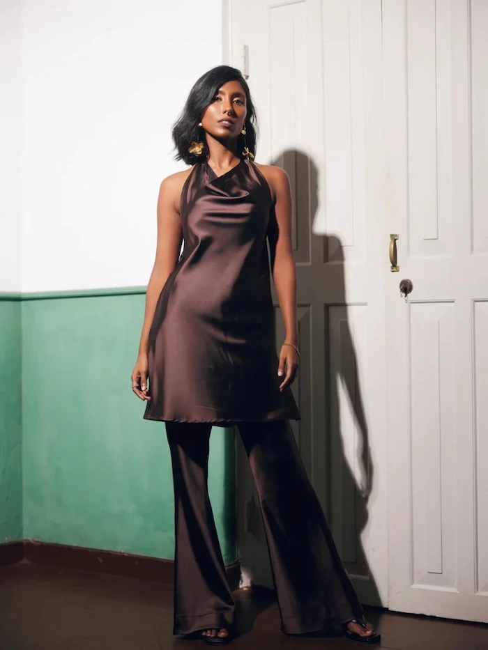 Brown satin halter tunic worn over matching wide leg trousers